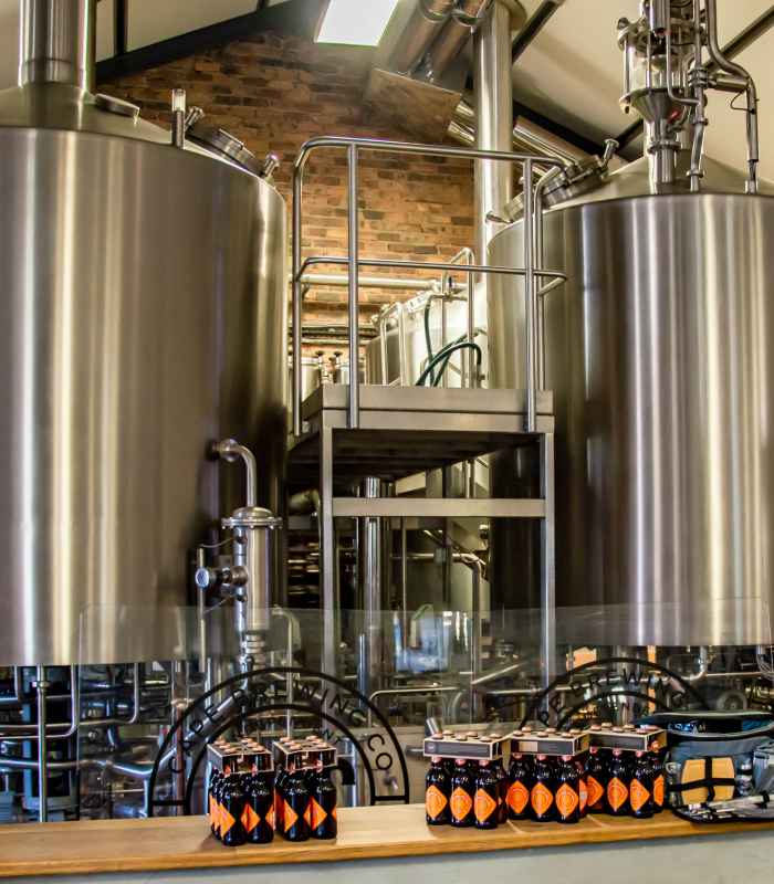 Brewery fermentation vats sanitized with chlorine dioxide for beverage processing and food safety compliance.