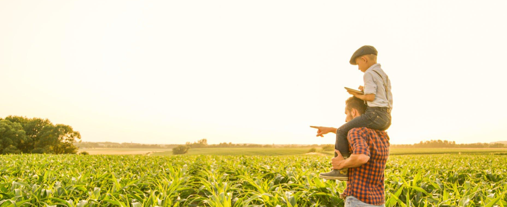 Farmer and child in field representing Selectrocide chlorine dioxide solutions for agriculture and food safety.